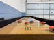 Indoor shuffleboard table with red and blue pucks ready for a game at 252 Barbera Dr, Davenport, FL 33897