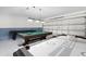 This large game room features a pool table and an air hockey table for entertainment at 252 Barbera Dr, Davenport, FL 33897