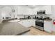 Well-lit kitchen with white cabinetry, stainless steel appliances, and a breakfast bar with views into the living space at 252 Barbera Dr, Davenport, FL 33897