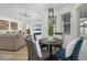 Open-concept living and dining area with contemporary furniture and a view of the pool through large windows at 252 Barbera Dr, Davenport, FL 33897