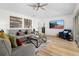 Inviting living area with a ceiling fan, large screen television, and comfortable seating arrangement on a stylish rug at 252 Barbera Dr, Davenport, FL 33897