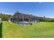 Screened-in pool with a lush green lawn at 252 Barbera Dr, Davenport, FL 33897