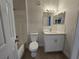 Bathroom with a single sink vanity, subway tile backsplash, and a tub and shower combo at 2572 Robert Trent Jones Dr # 1227, Orlando, FL 32835