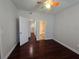 Spacious bedroom with hardwood flooring, and a view of the ensuite bath and kitchen through open doorways at 2572 Robert Trent Jones Dr # 1227, Orlando, FL 32835