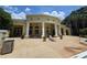 Elegant clubhouse exterior featuring large columns and a lounge chair near the outdoor pool at 2572 Robert Trent Jones Dr # 1227, Orlando, FL 32835