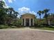 Exterior view of brick community building with grand white pillars at 2572 Robert Trent Jones Dr # 1227, Orlando, FL 32835