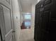 Bright entryway leading into a cozy living room with wood floors and lots of natural light at 2572 Robert Trent Jones Dr # 1227, Orlando, FL 32835