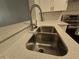 Close-up shot of kitchen sink with stainless steel basin and quartz countertop at 2572 Robert Trent Jones Dr # 1227, Orlando, FL 32835