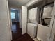 Stacked white washer and dryer unit with laundry closet in neutral hallway near bedroom at 2572 Robert Trent Jones Dr # 1227, Orlando, FL 32835