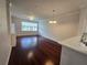 Open-concept living room with hardwood floors, a dining area, and a large window providing natural light at 2572 Robert Trent Jones Dr # 1227, Orlando, FL 32835