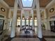 Grand lobby featuring tile flooring, large columns, and a decorative chandelier centerpiece at 2572 Robert Trent Jones Dr # 1227, Orlando, FL 32835