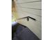 Outdoor stairway showing a black metal handrail and light yellow siding at 2572 Robert Trent Jones Dr # 1227, Orlando, FL 32835