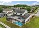 Aerial view of a home with a screened pool and spa area, surrounded by a well-maintained backyard at 2616 Marg Ln, Kissimmee, FL 34758