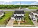 Aerial view of a charming two-story home with a welcoming front porch and a well-manicured lawn at 2616 Marg Ln, Kissimmee, FL 34758