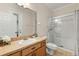 Clean bathroom with a modern vanity, a tiled floor, and a shower with glass doors at 2616 Marg Ln, Kissimmee, FL 34758