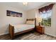 Bedroom featuring wooden bedframe and a picture window at 2616 Marg Ln, Kissimmee, FL 34758