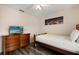 Bedroom featuring wooden bedframe, dresser and a night picture at 2616 Marg Ln, Kissimmee, FL 34758