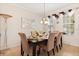 Elegant dining room featuring stylish decor, a modern chandelier, and ample natural light at 2616 Marg Ln, Kissimmee, FL 34758