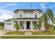 Charming two-story home with a welcoming front porch and well-manicured landscaping at 2616 Marg Ln, Kissimmee, FL 34758