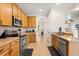 Functional kitchen featuring stainless steel appliances, wooden cabinets, and practical layout at 2616 Marg Ln, Kissimmee, FL 34758
