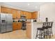 Well-equipped kitchen with stainless steel appliances, breakfast bar, and wood cabinetry at 2616 Marg Ln, Kissimmee, FL 34758