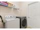 Bright laundry room featuring modern washer and dryer, and convenient shelving for storage at 2616 Marg Ln, Kissimmee, FL 34758