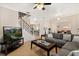 Open concept living space with tile floors, a decorative staircase, and a seamless flow to other areas at 2616 Marg Ln, Kissimmee, FL 34758