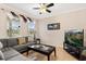 Comfortable living room with a cozy sofa, natural light, and a ceiling fan at 2616 Marg Ln, Kissimmee, FL 34758