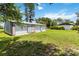 Lush backyard features multiple garages, providing ample storage and parking space for vehicles and equipment at 2740 Barker Rd, St Cloud, FL 34771