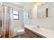 Traditional bathroom with tile floor, shower-tub combo, vanity, and a mirrored wall at 2740 Barker Rd, St Cloud, FL 34771