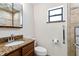Bathroom featuring granite countertops, modern fixtures, and convenient accessibility features at 2740 Barker Rd, St Cloud, FL 34771