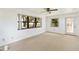Bright bedroom featuring neutral carpet and windows with views of the lake at 2740 Barker Rd, St Cloud, FL 34771