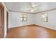 Bedroom featuring wood floor, ceiling fan, and decorative wallpaper trim at 2740 Barker Rd, St Cloud, FL 34771