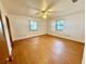 A clean and bright bedroom features two large windows and attractive hardwood flooring at 2740 Barker Rd, St Cloud, FL 34771
