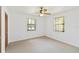 Bright bedroom featuring neutral carpet, ceiling fan, and two windows at 2740 Barker Rd, St Cloud, FL 34771