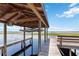 Boat lift and bench seating inside dock house with view of lake at 2740 Barker Rd, St Cloud, FL 34771
