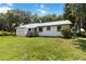 Charming single-story home with a metal roof, one-car garage and a well-maintained lawn at 2740 Barker Rd, St Cloud, FL 34771
