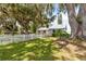 Charming home featuring a white picket fence and large trees draped with Spanish moss at 2740 Barker Rd, St Cloud, FL 34771