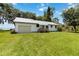 View of a charming single-story home with a metal roof and well-maintained lawn at 2740 Barker Rd, St Cloud, FL 34771