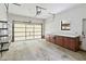 Spacious garage with door open, concrete floor, and built-in cabinets at 2740 Barker Rd, St Cloud, FL 34771