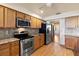 Well-equipped kitchen featuring stainless steel appliances, wood cabinets, and granite countertops at 2740 Barker Rd, St Cloud, FL 34771