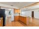 Eat-in kitchen features wood cabinets, granite counters, breakfast bar and stainless steel refrigerator at 2740 Barker Rd, St Cloud, FL 34771
