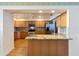 Charming kitchen with wooden cabinets, granite countertops, and stainless steel appliances at 2740 Barker Rd, St Cloud, FL 34771