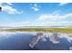 Lake view from the dock, reflecting the clouds at 2740 Barker Rd, St Cloud, FL 34771