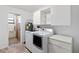 Functional laundry room with modern washer, dryer, and convenient built-in storage cabinets at 2740 Barker Rd, St Cloud, FL 34771