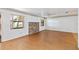 Bright living room with hardwood floors, a brick fireplace, and scenic views from large windows at 2740 Barker Rd, St Cloud, FL 34771