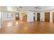 Spacious living room with hardwood floors, a ceiling fan, and an open concept to the kitchen at 2740 Barker Rd, St Cloud, FL 34771