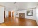 Spacious living room with hardwood floors, a brick accent wall, and multiple entry points at 2740 Barker Rd, St Cloud, FL 34771
