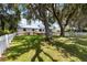 Charming home with a well-maintained yard, white picket fence, and shade trees, creating a welcoming atmosphere at 2740 Barker Rd, St Cloud, FL 34771