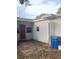Backyard view of a single-story home featuring an entrance and small, partially-paved yard at 380 S Echo Dr, Lake Alfred, FL 33850